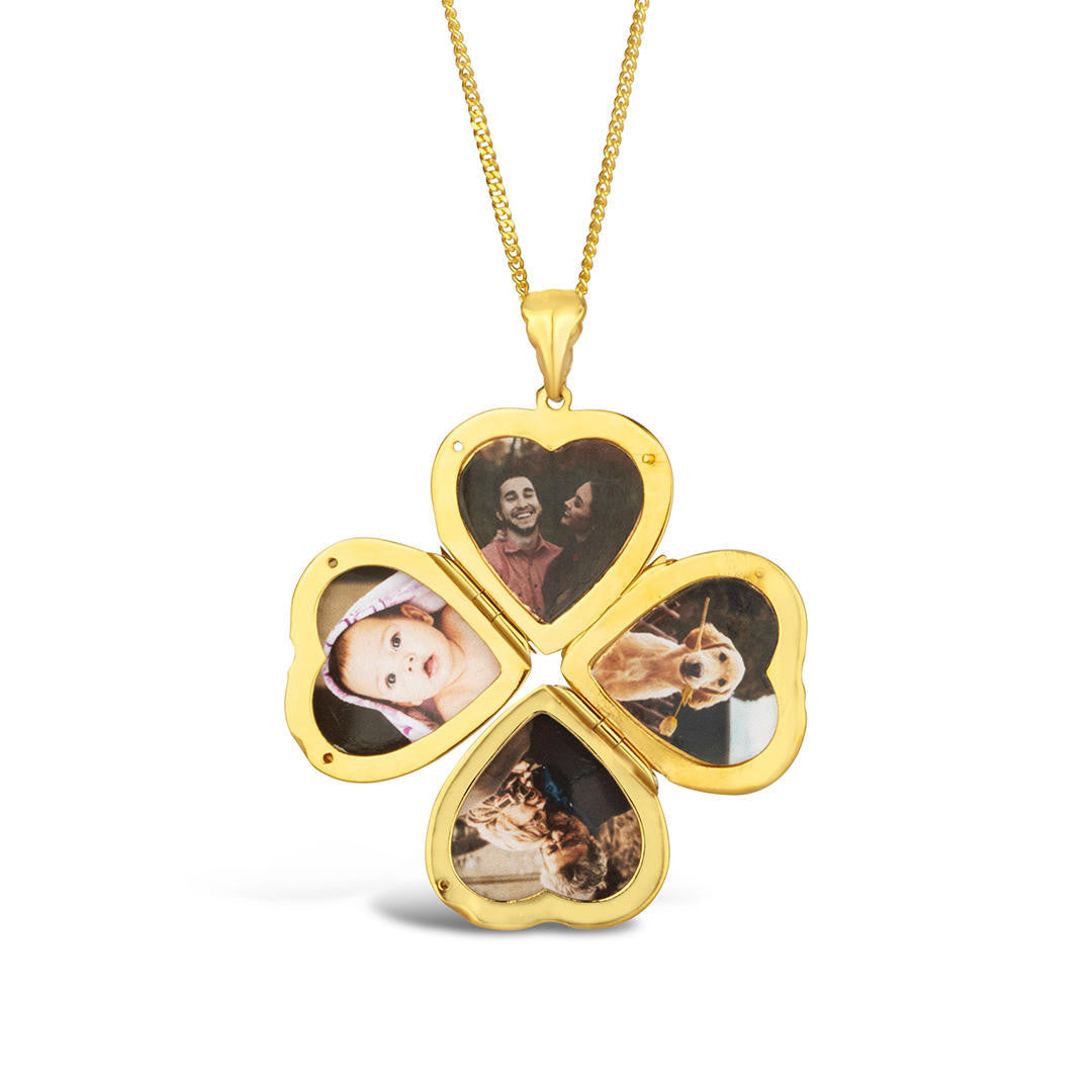 opened four photo heart locket in gold on a white background