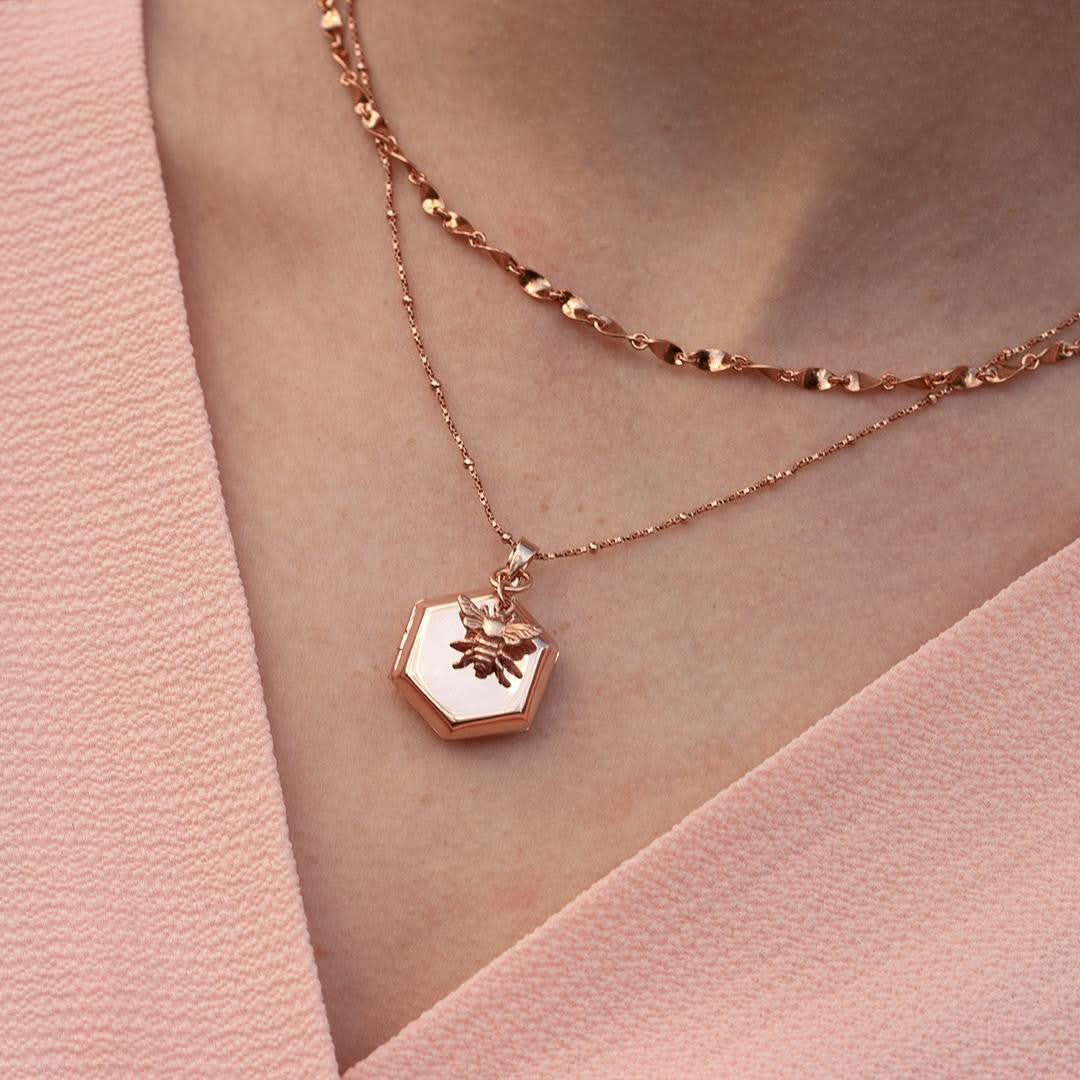 closeup of model wearing rose gold locket