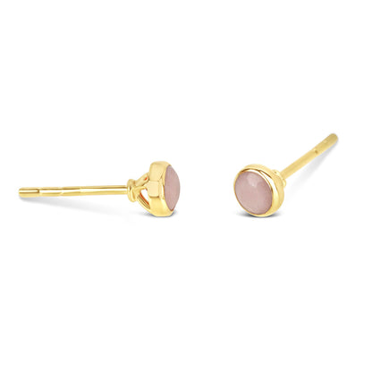 Pink opal mini stud earrings in gold facing the side on a white background