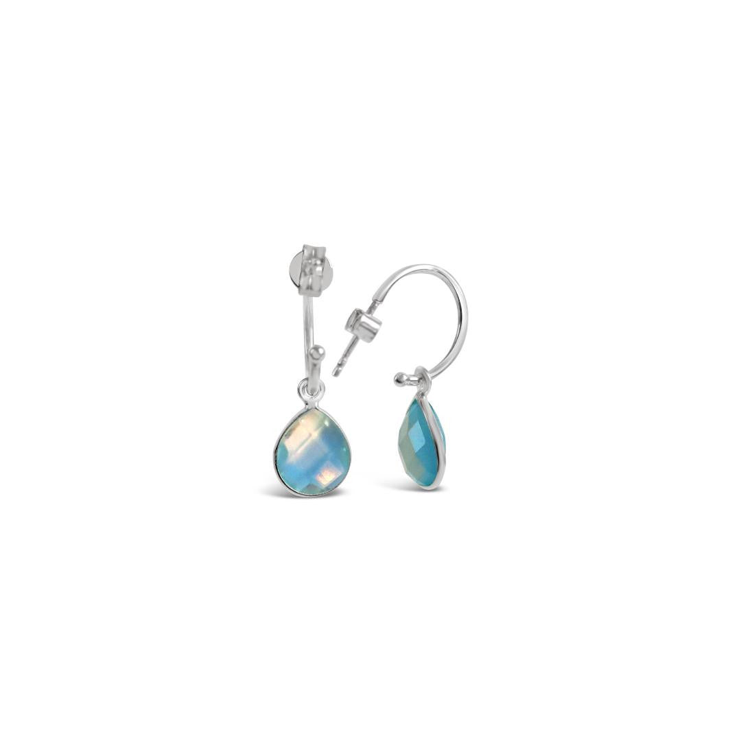 blue topaz drop hoop earrings in silver on a white background