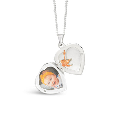 opened secret silver heart locket with rose gold bird charm and photo inside
