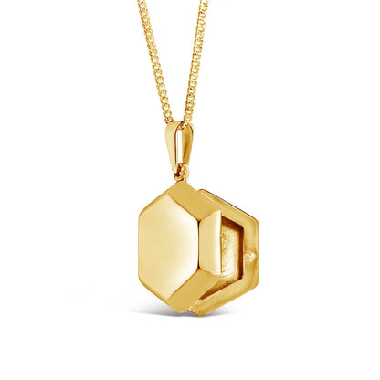 opened hexagon shaped locket in gold on a white background