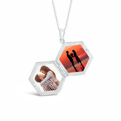 opened hexagon locket in silver with family photos inside