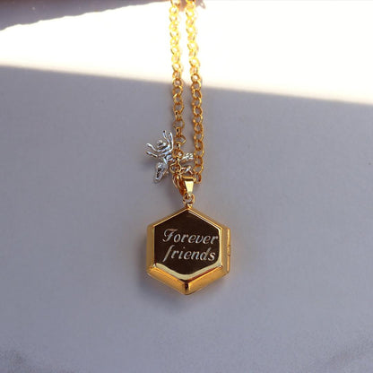 hexagon locket in gold with engraved message on locket