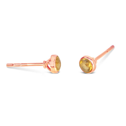 Citrine mini stud earrings in rose gold facing the side on a white background