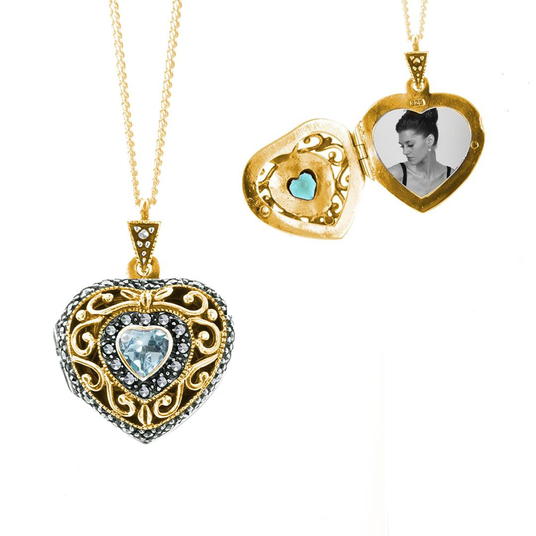 blue topaz vintage heart locket in gold with photo inside on a white background