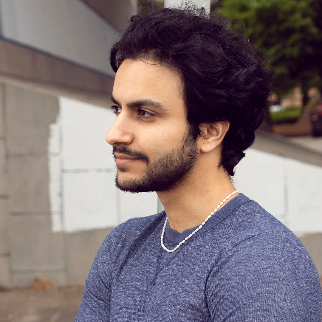 model wearing men's seed pearl necklace