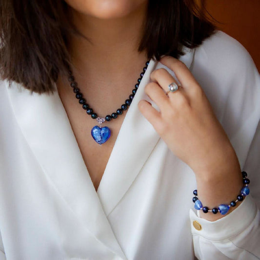 model wearing midnight pearl heart bracelet and necklace on a white background