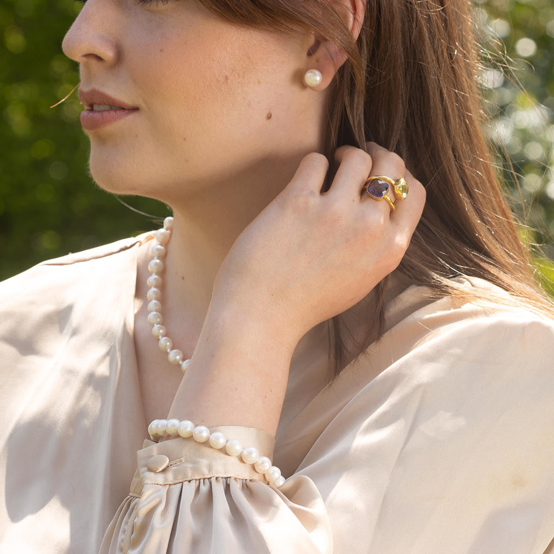 close up of model wearing classic pearl bracelet in ivory