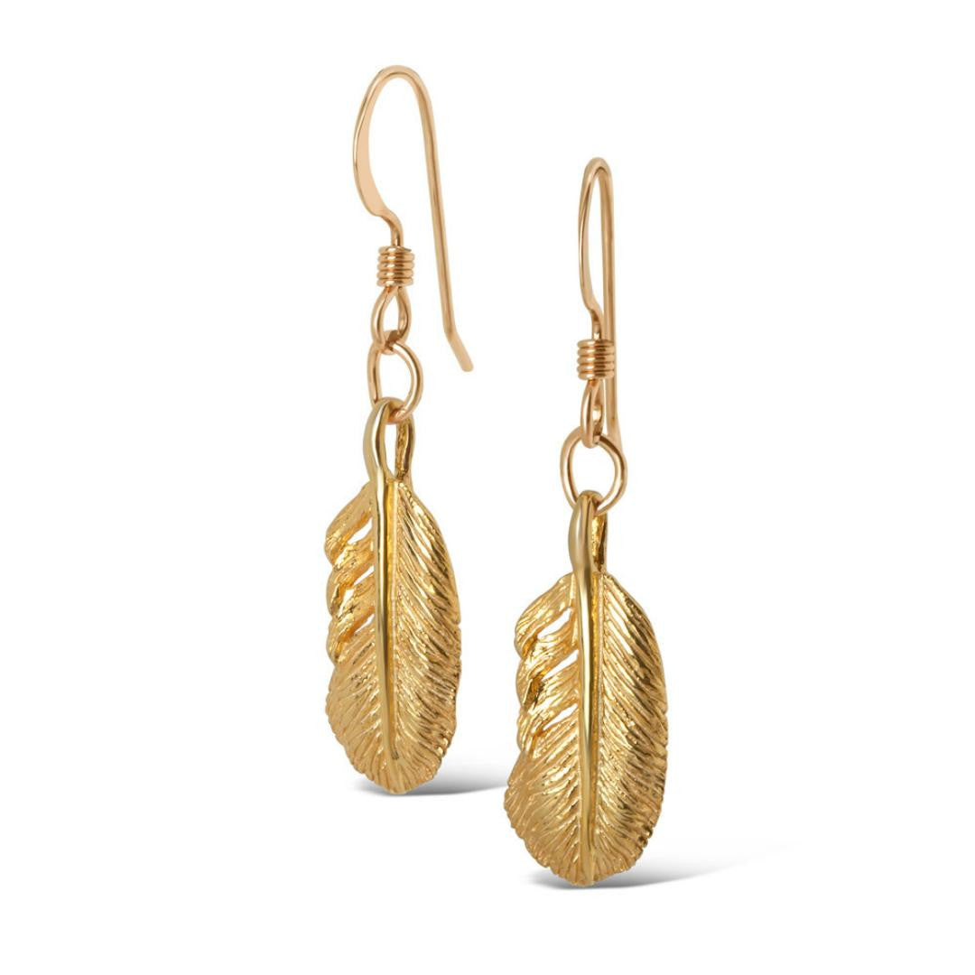 gold feather earrings on a white background