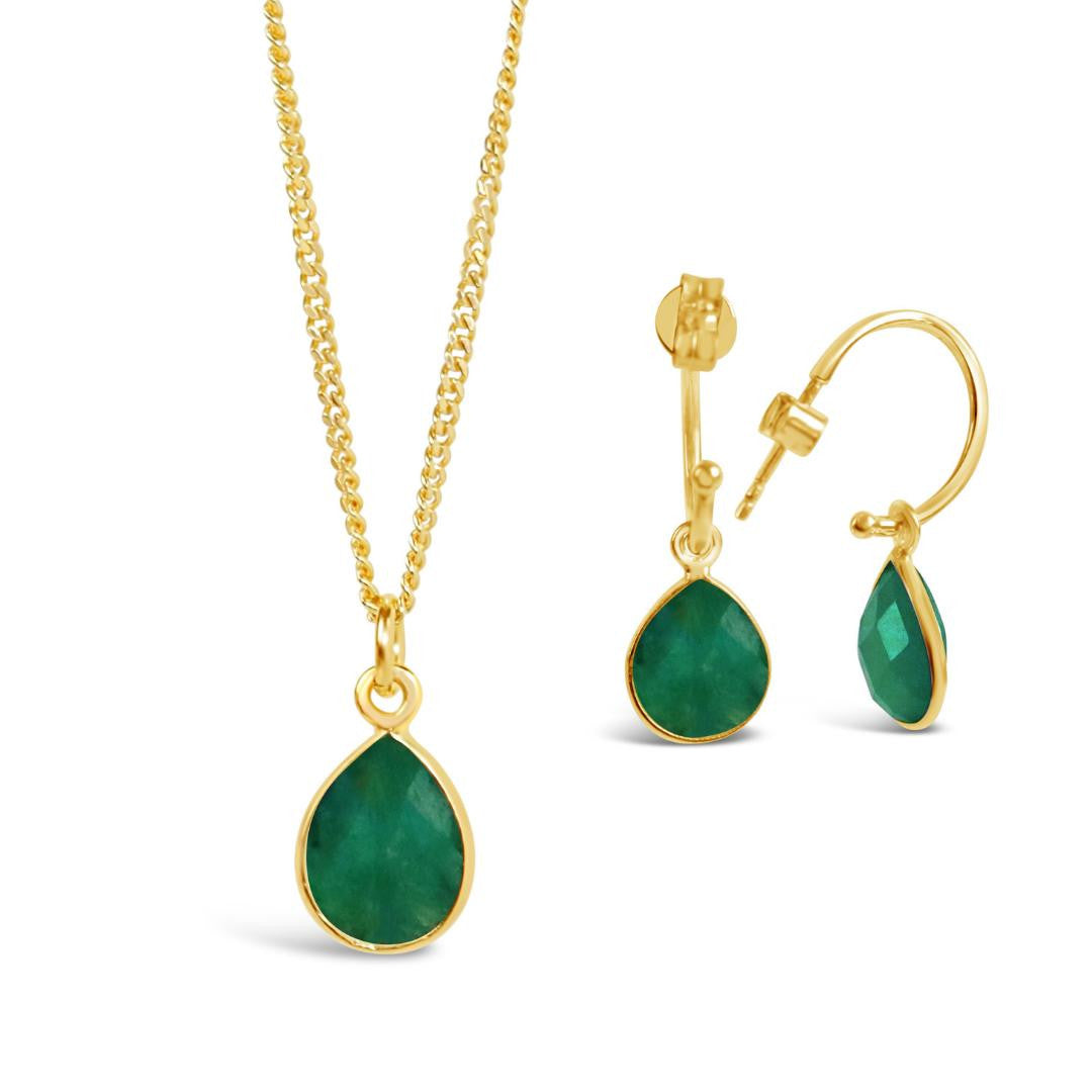 emerald drop hoop earrings in gold on a white background