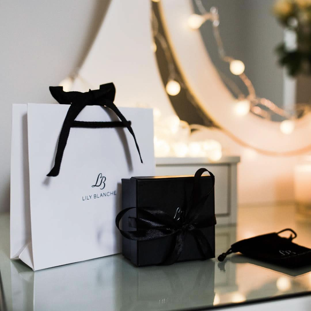 lily blanche gift bag, gift box, and anti-tarnish bag sitting on a vanity table