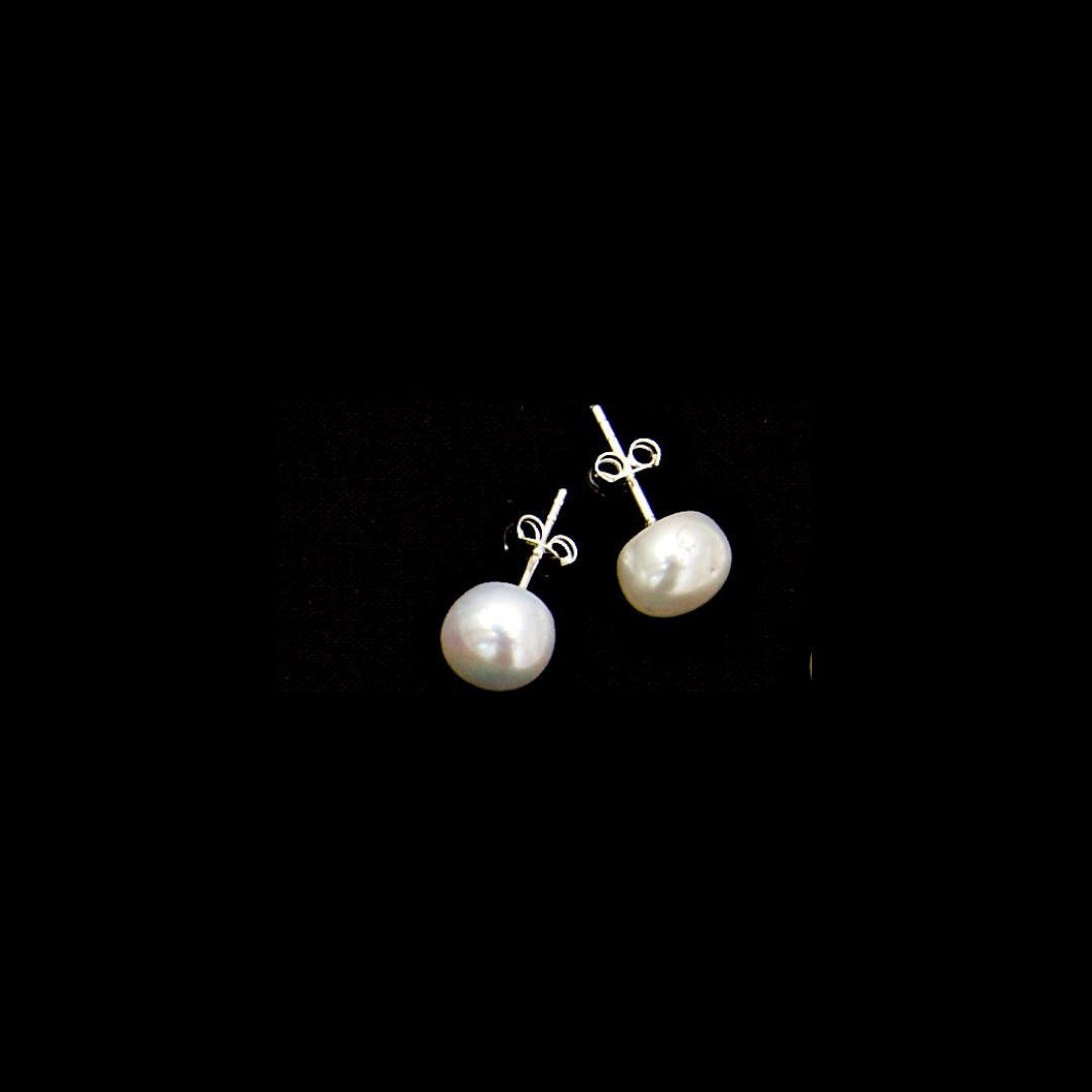 classic pearl earrings in ivory on a black background