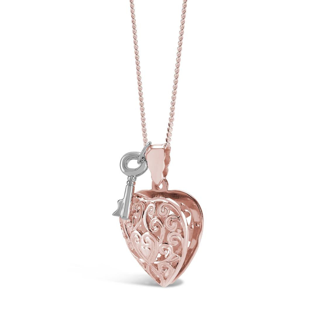 rose gold key locket with silver key charm on a white background