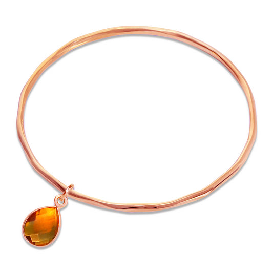 citrine charm bangle in rose gold on a white background