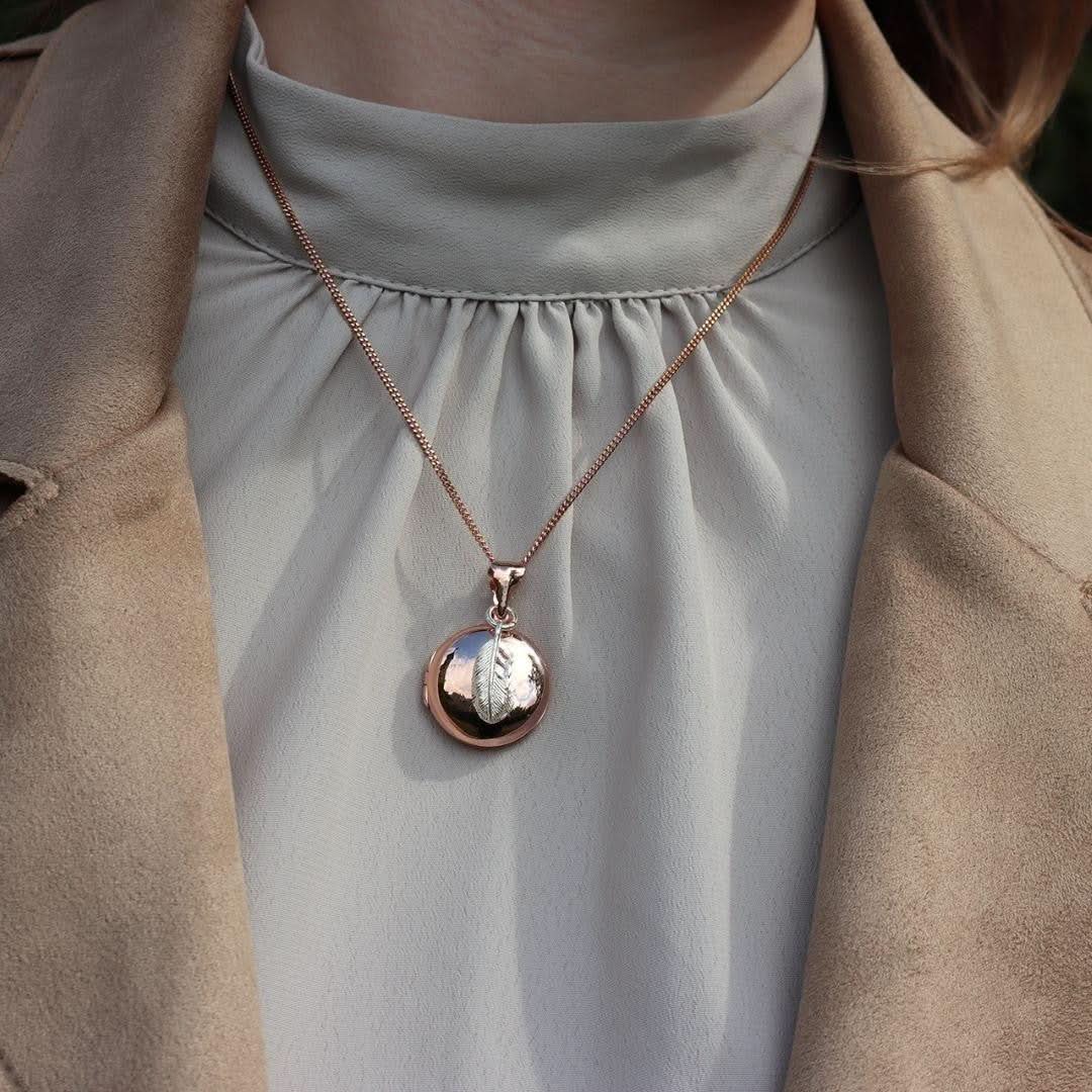 model wearing rose gold feather locket with silver feather charm