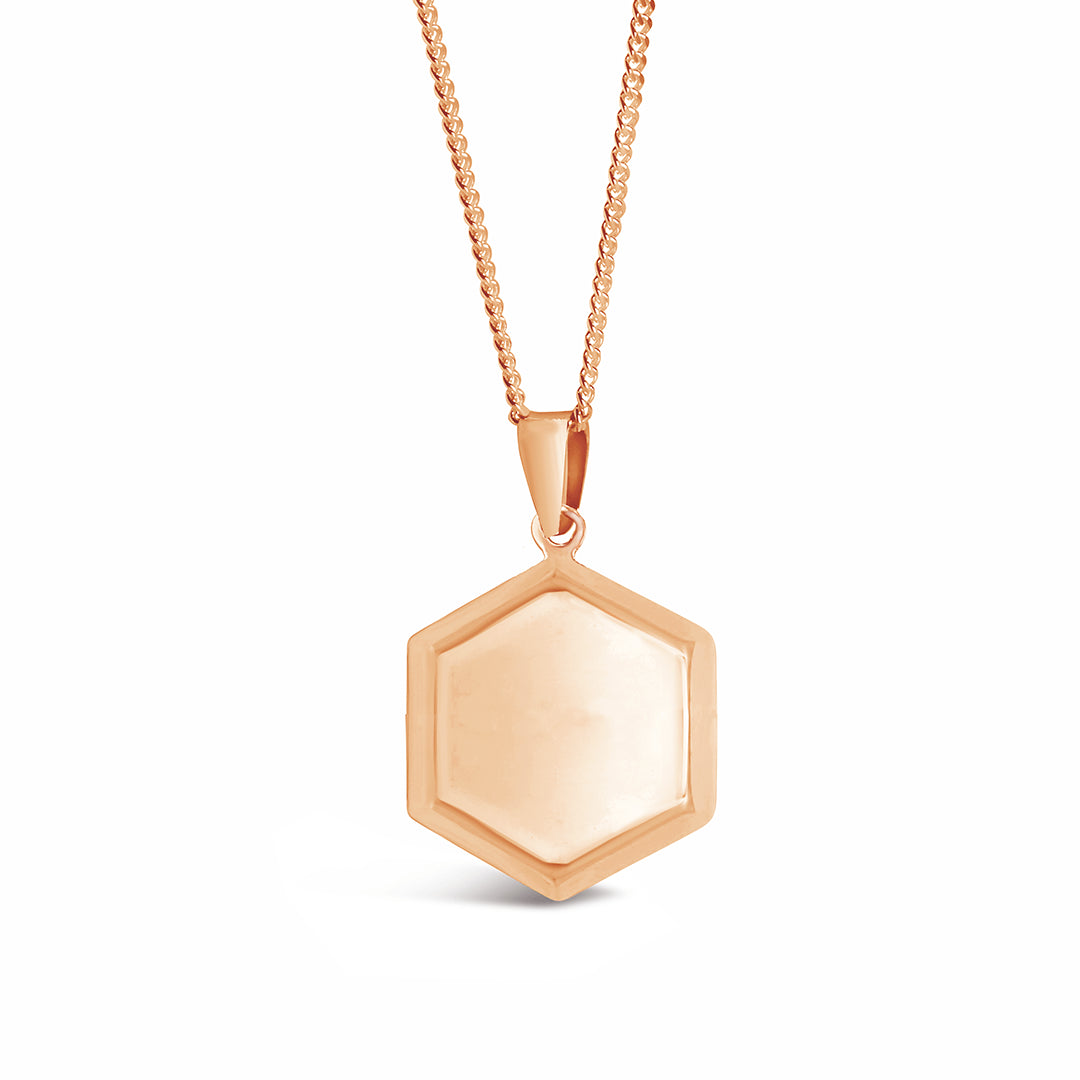 fron view of men's hexagon locket in rose gold on a white background  