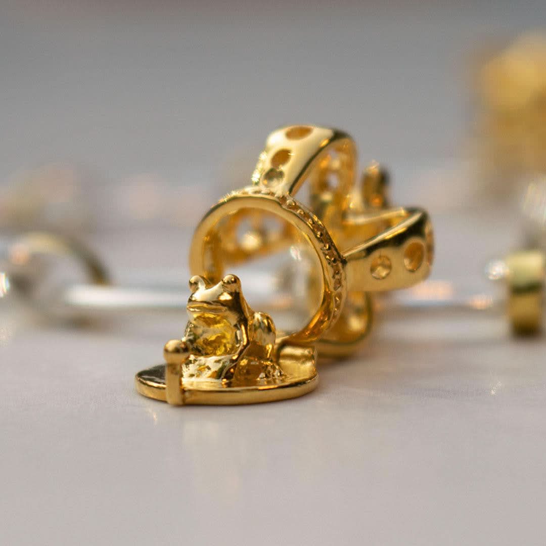 opened magical crown charm in gold 