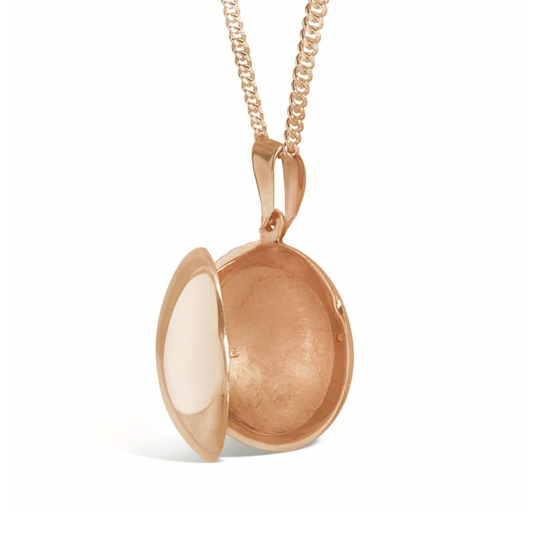 men's round locket necklace in rose gold on a white background