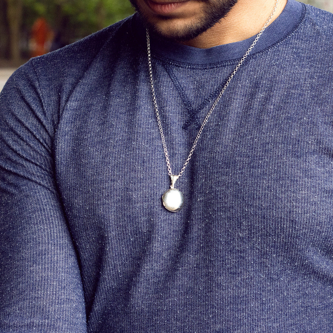 model wearing men's round locket necklace in silver 