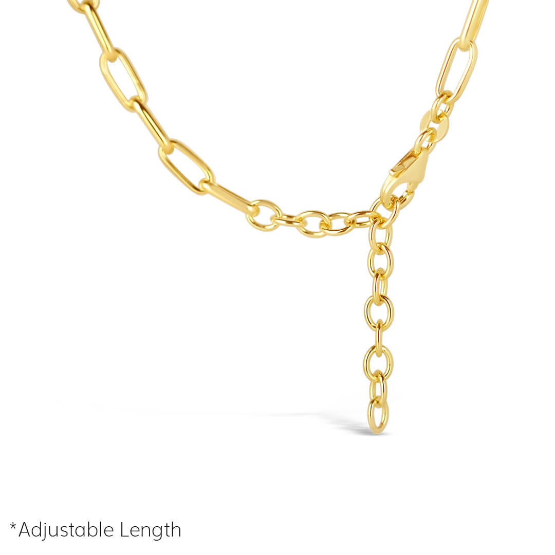closeup of paperclip chain necklace in gold on a white background