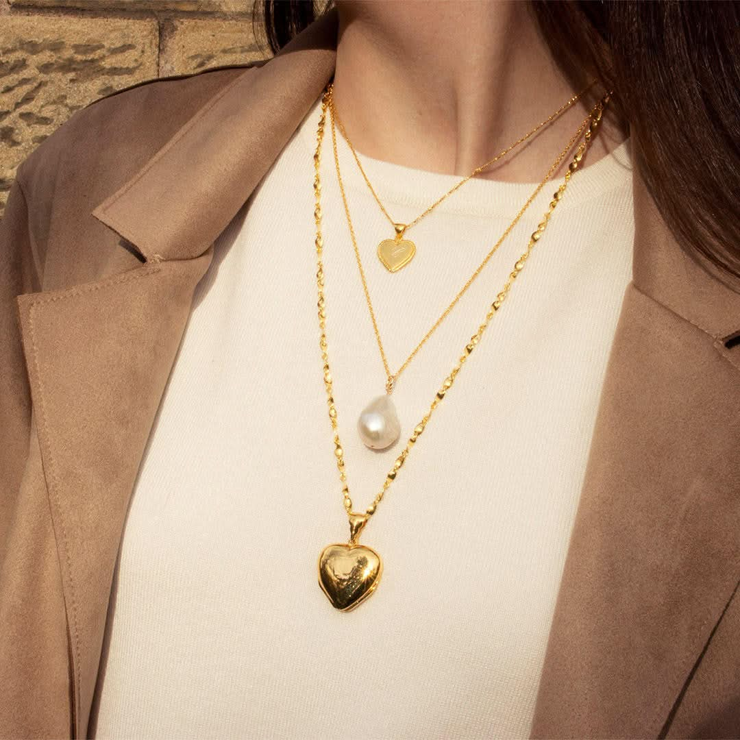 women modelling four photo heart locket in gold