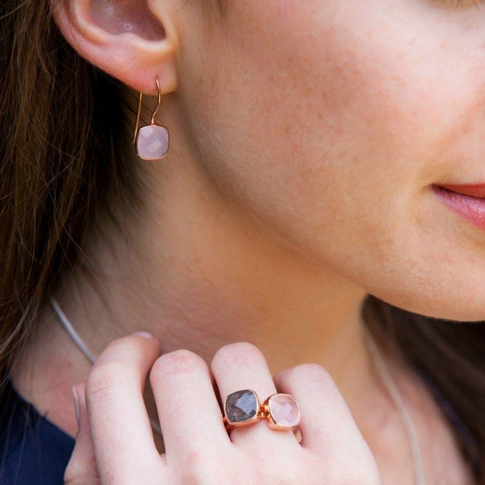 model wearing rose quartz earrings with matching cocktail ring 