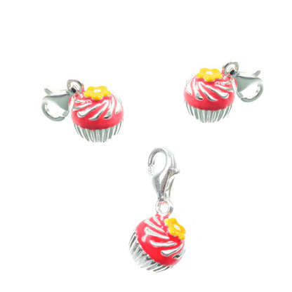 three cup cake charms being displayed on a white background
