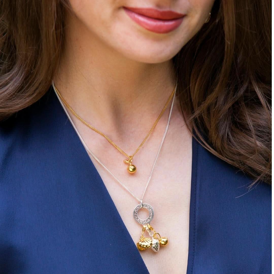 model wearing multiple magical charm necklaces
