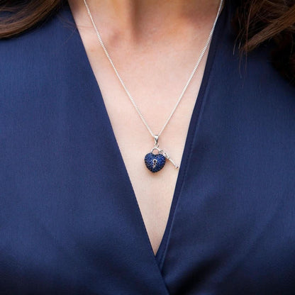 close up of model wearing key to my heart pendant in blue