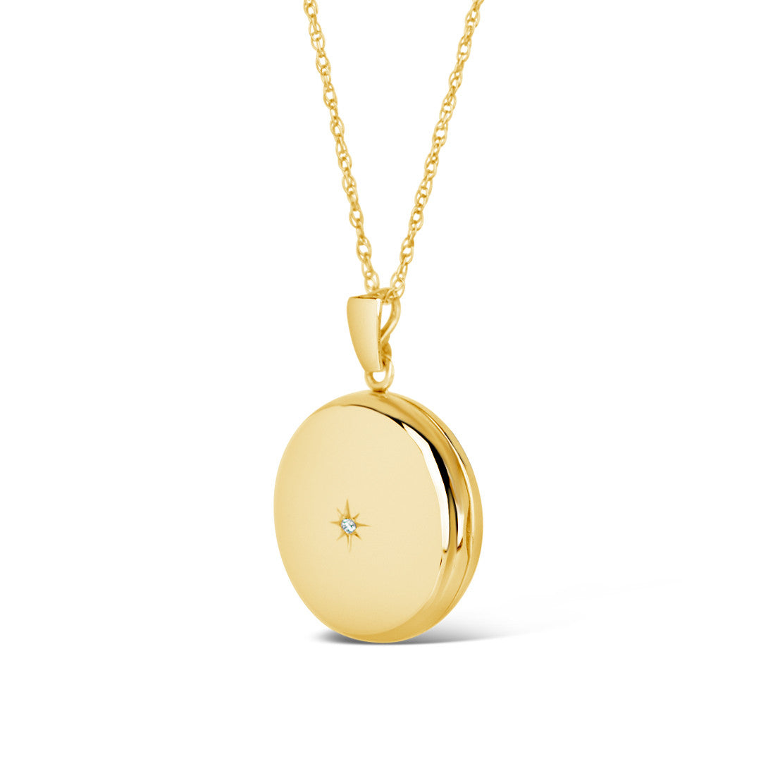 round diamond locket in gold on a white background