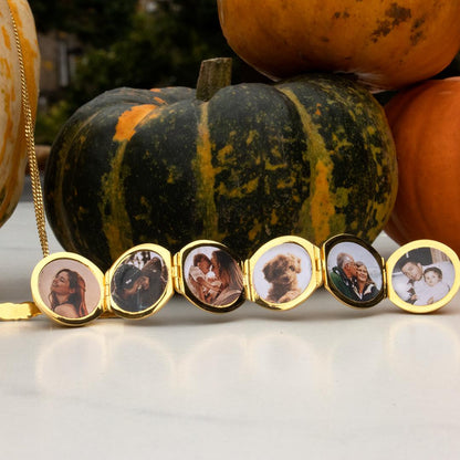 opened memory keeper locket with photos Infront of pumpkin 