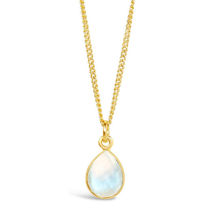 moonstone charm necklace in gold on a white background