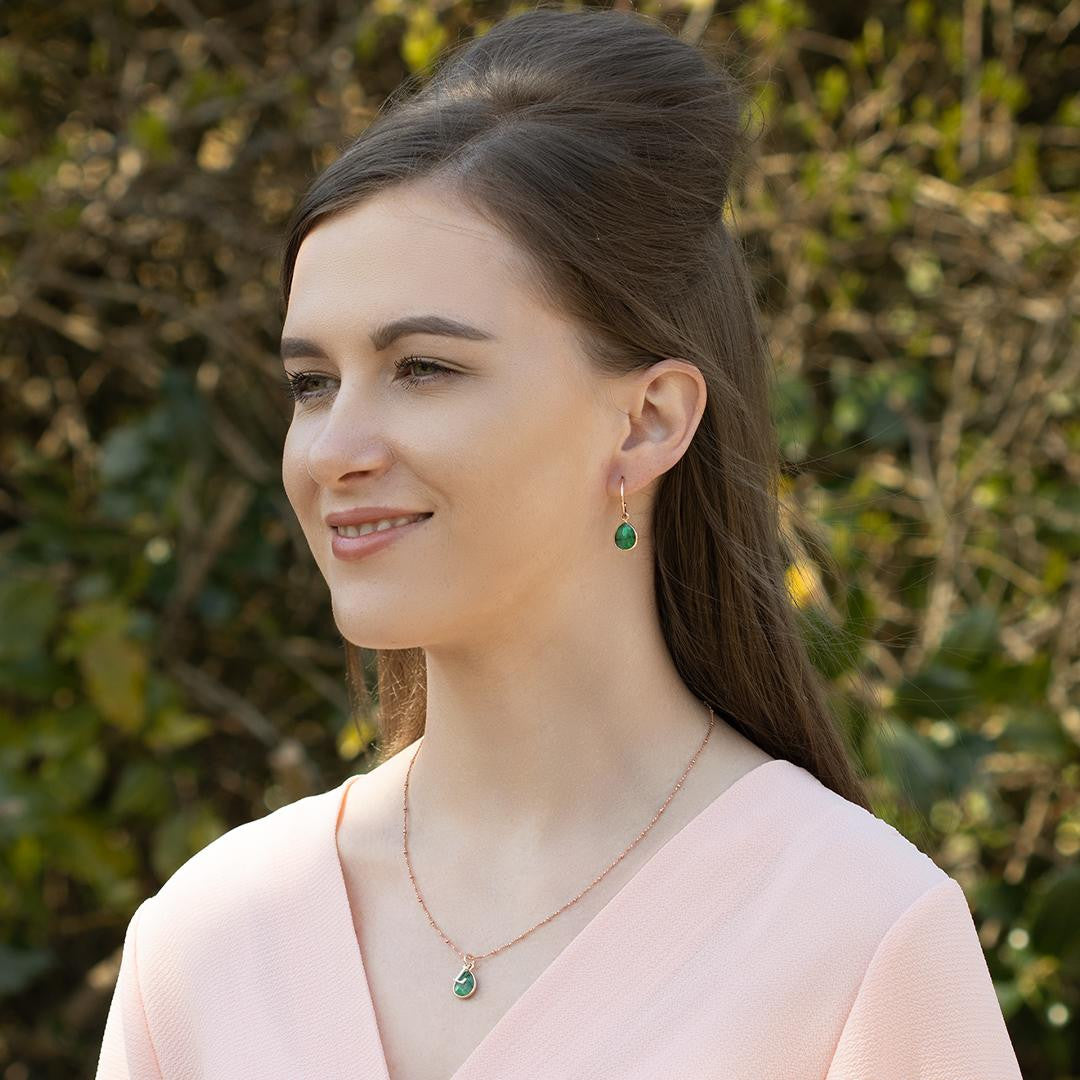 model wearing emerald charm necklace in rose gold