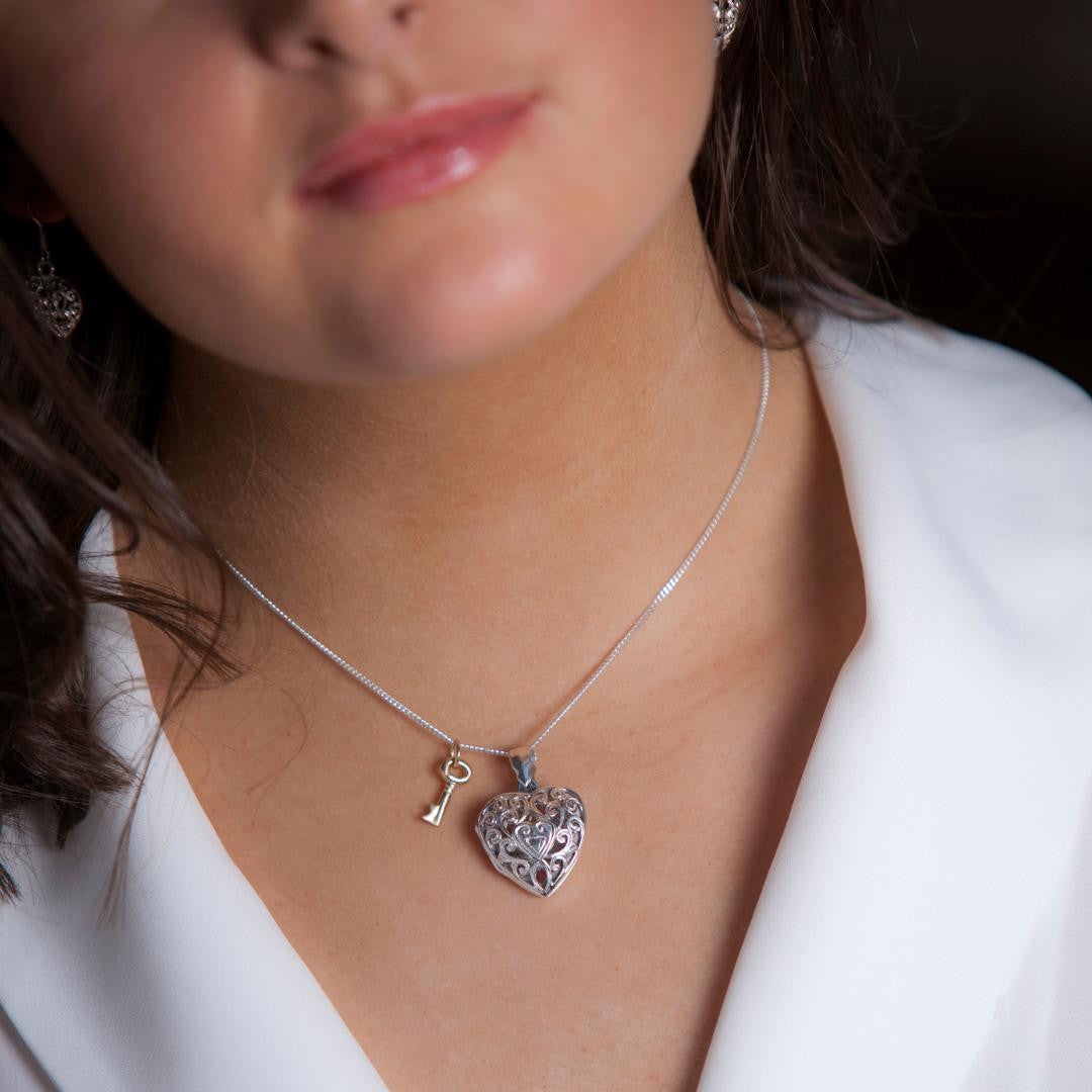 model wearing key locket in silver with silver key charm on chain