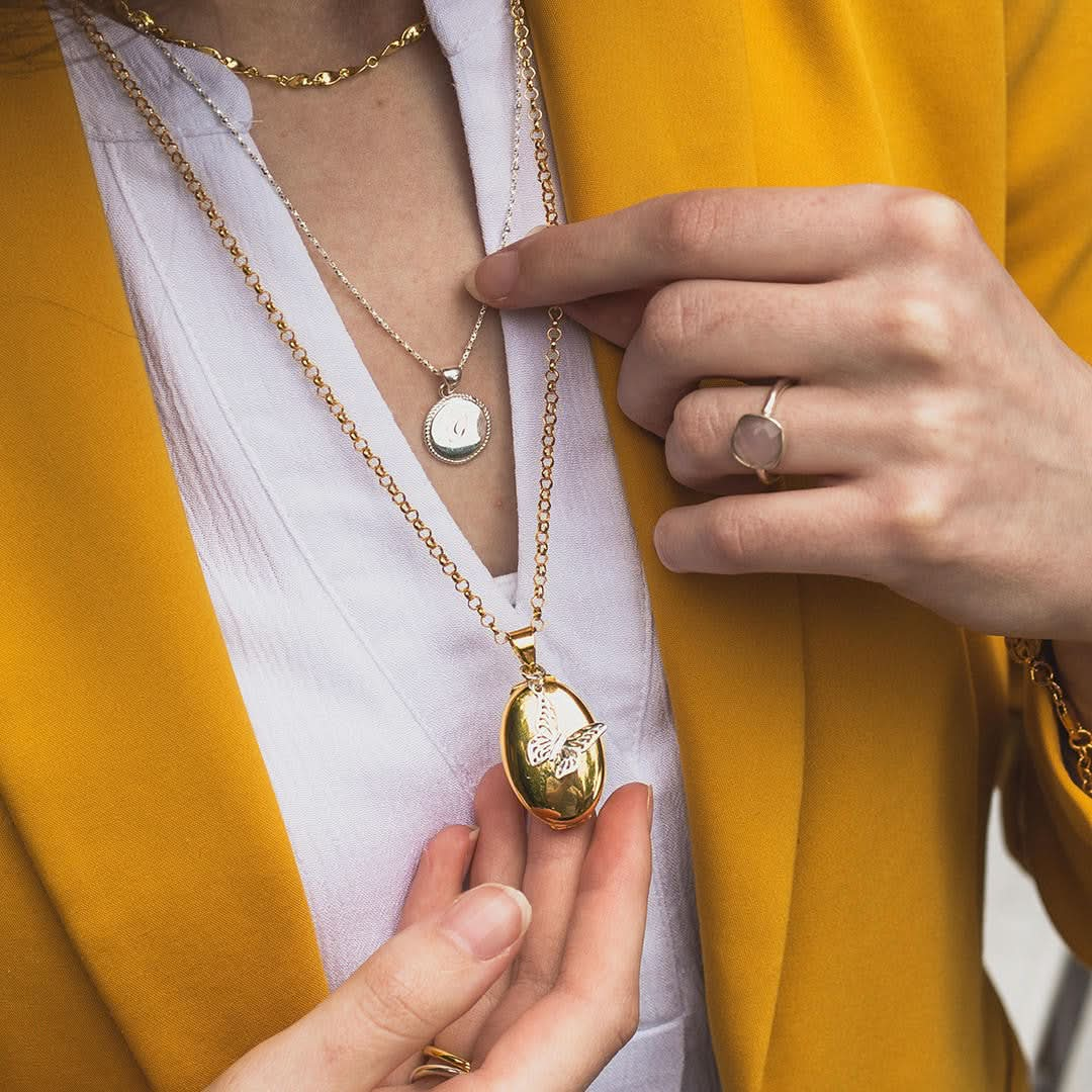 Women modelling four photo oval butterfly locket