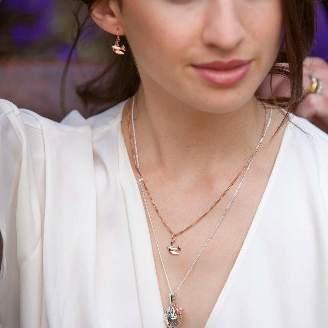 model wearing rose gold bird earrings