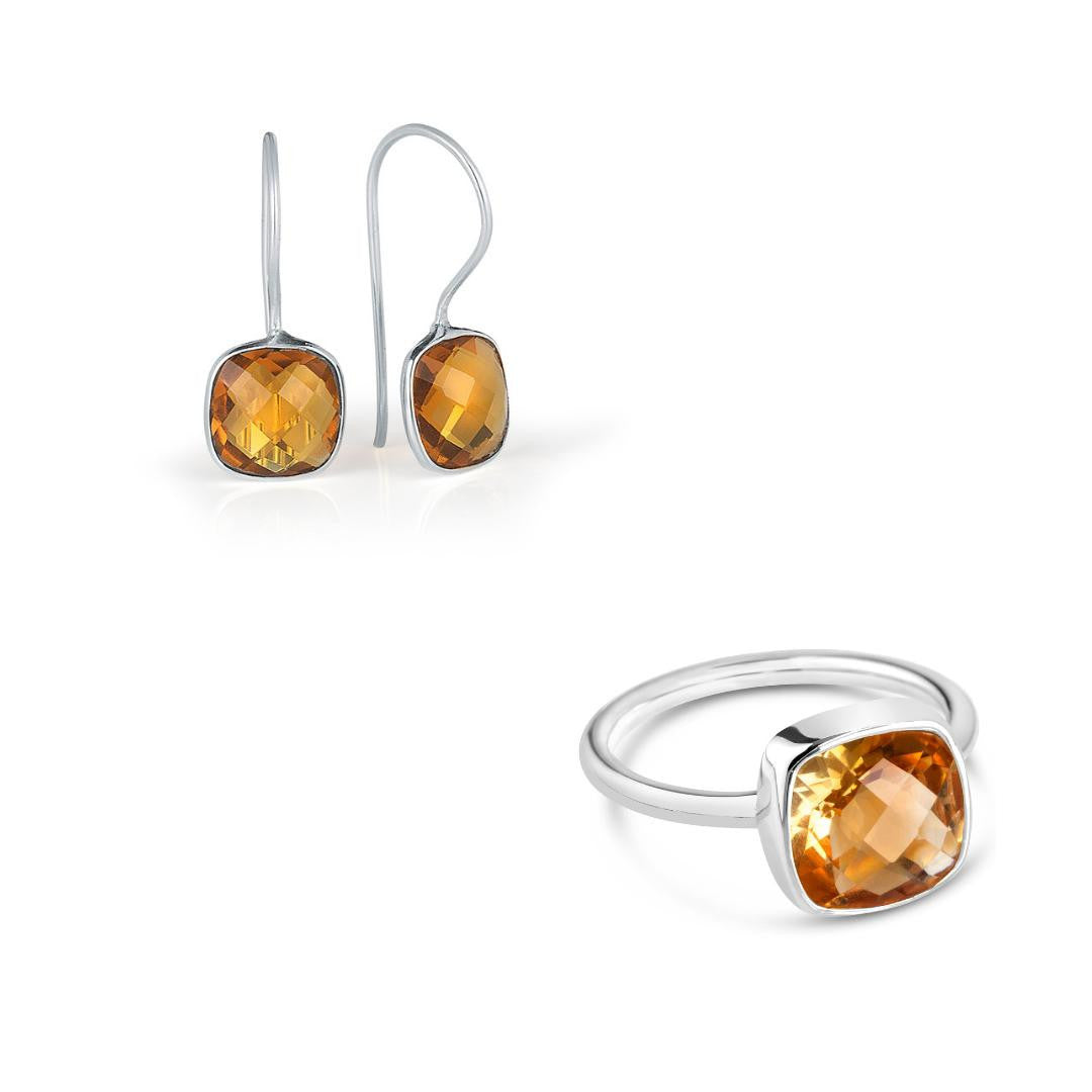 citrine cocktail ring and drop hoop earrings in silver on a white background