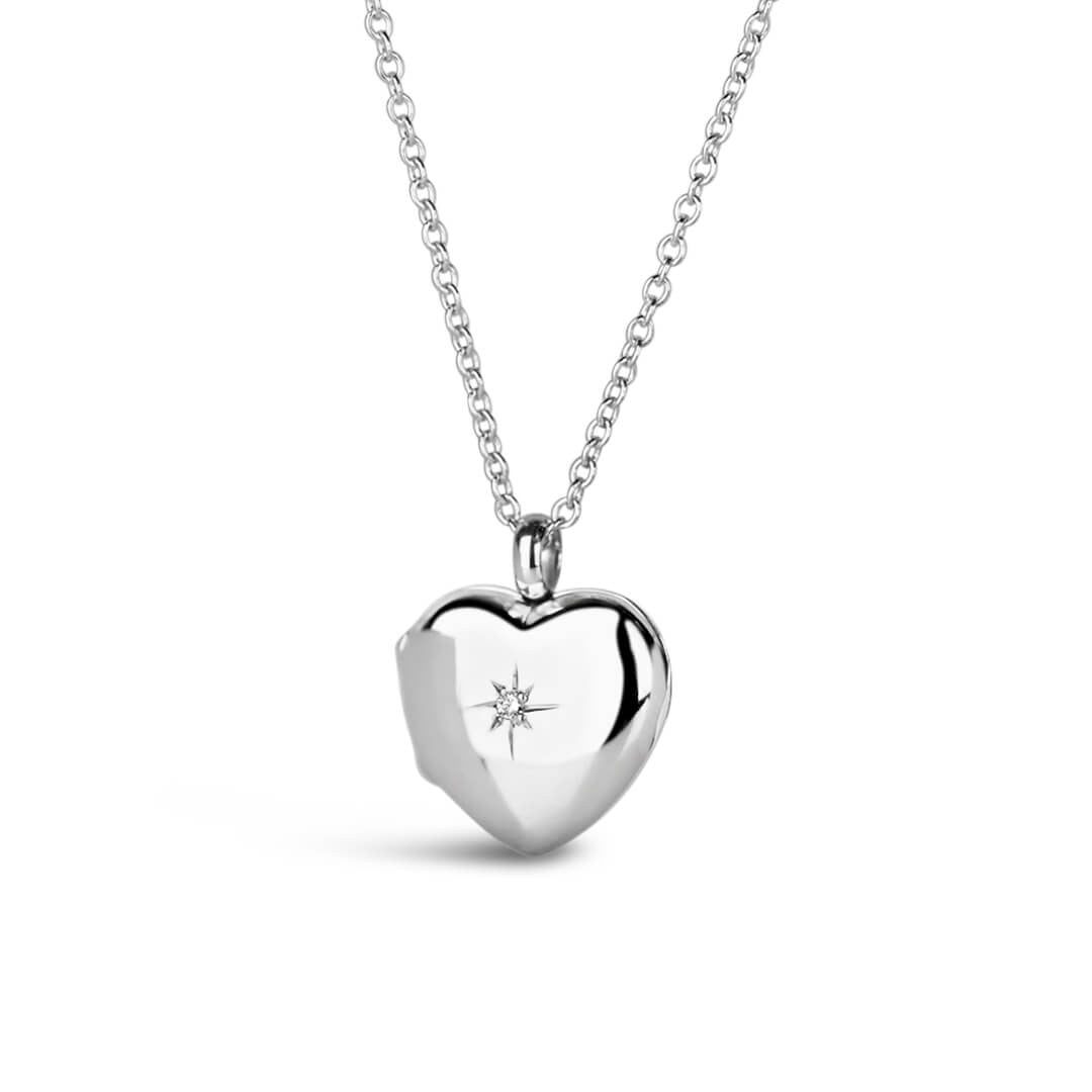 front view of a heart shaped locket in silver on a silver chain with a diamond decoration on a white background