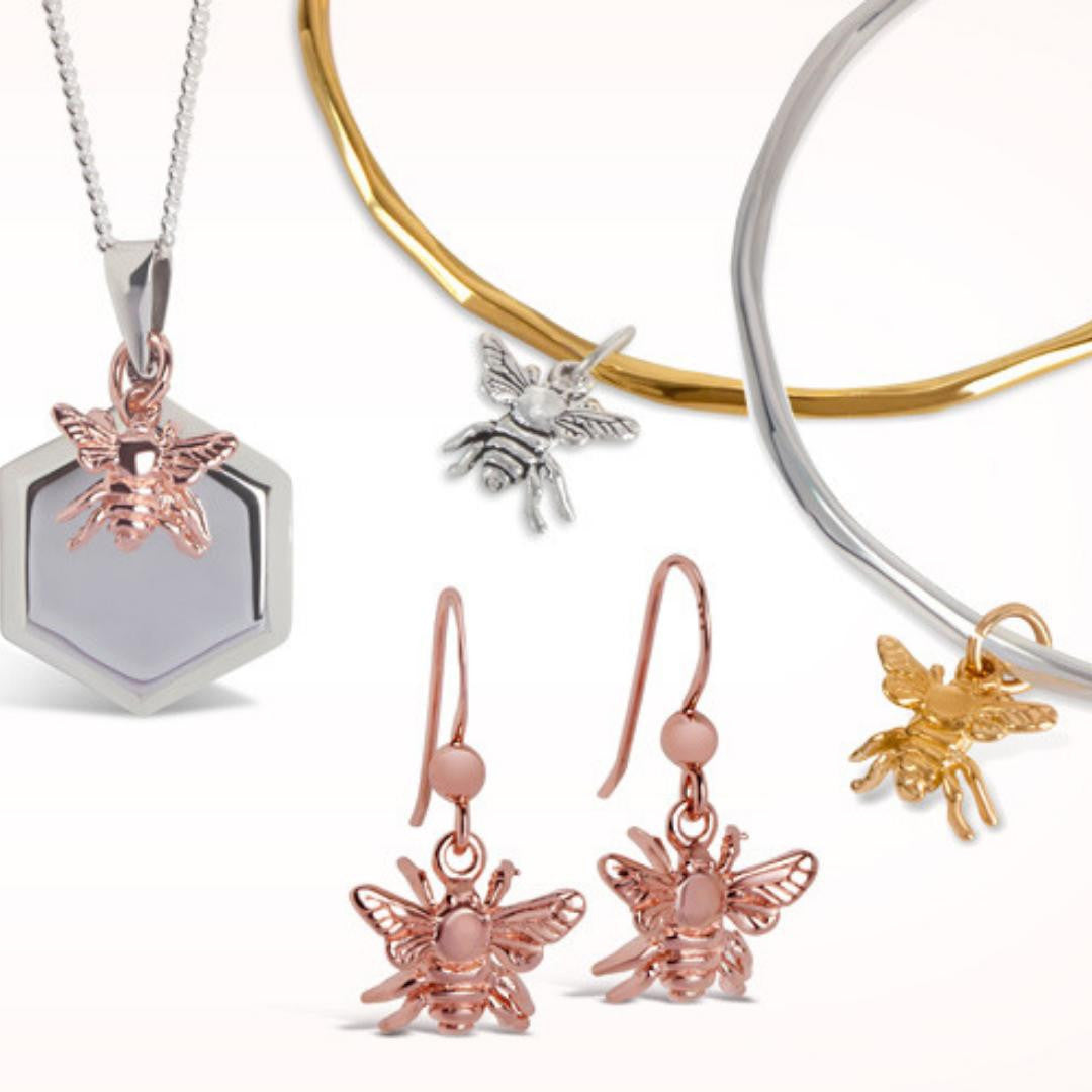 collection of bee jewellery on a white background