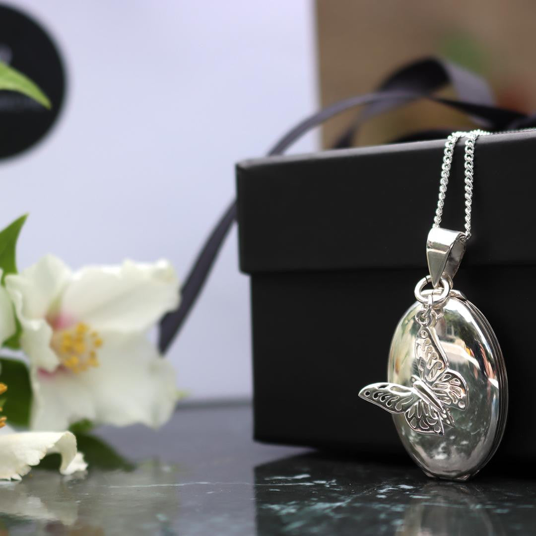 Lily Blanche white gold oval shaped locket with butterfly charm