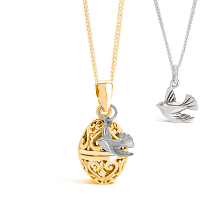 gold bird locket with silver bird charm on a white background