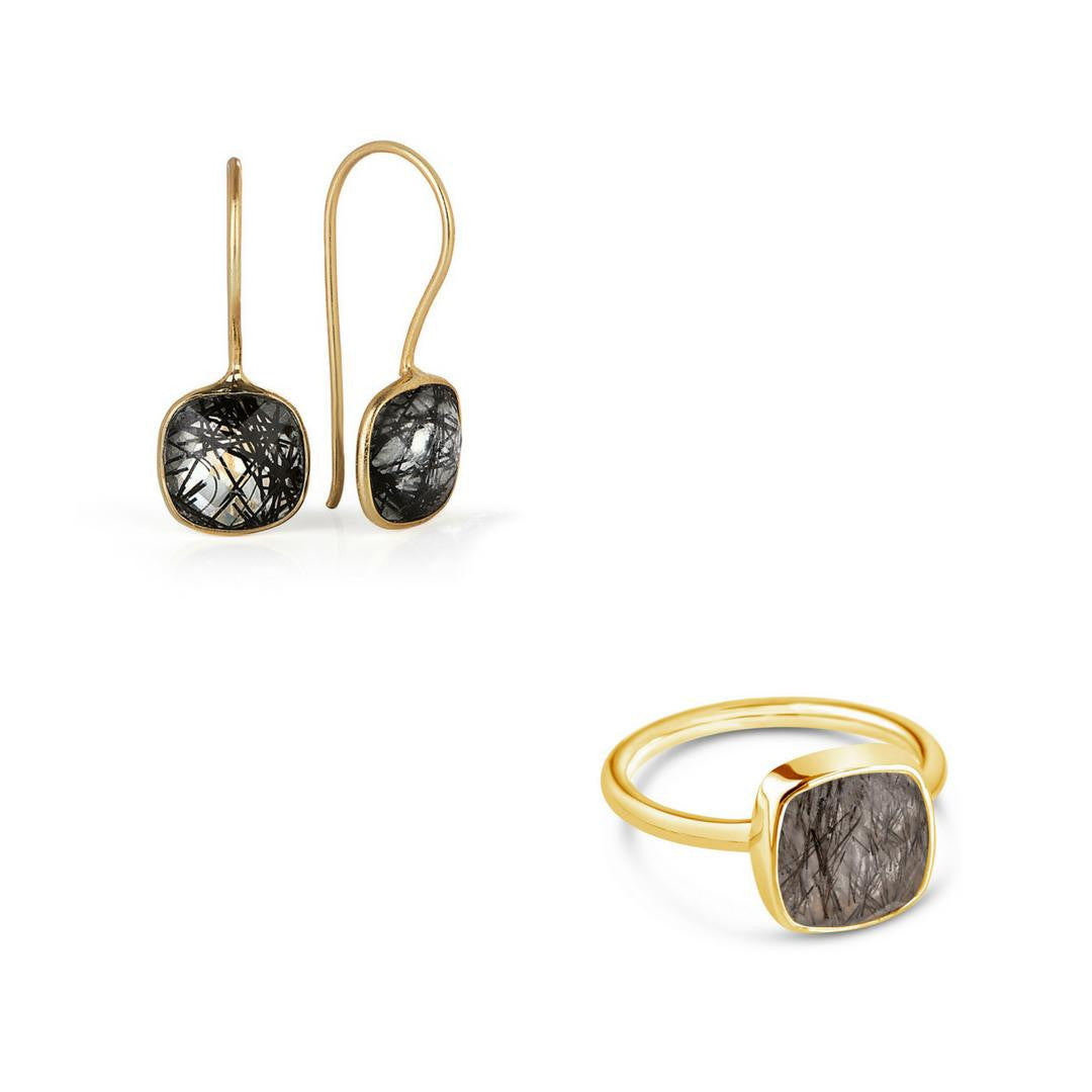 rutilated quartz cocktail ring in gold with matching earrings on a white background