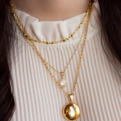 model wearing white quartz charm necklace in gold