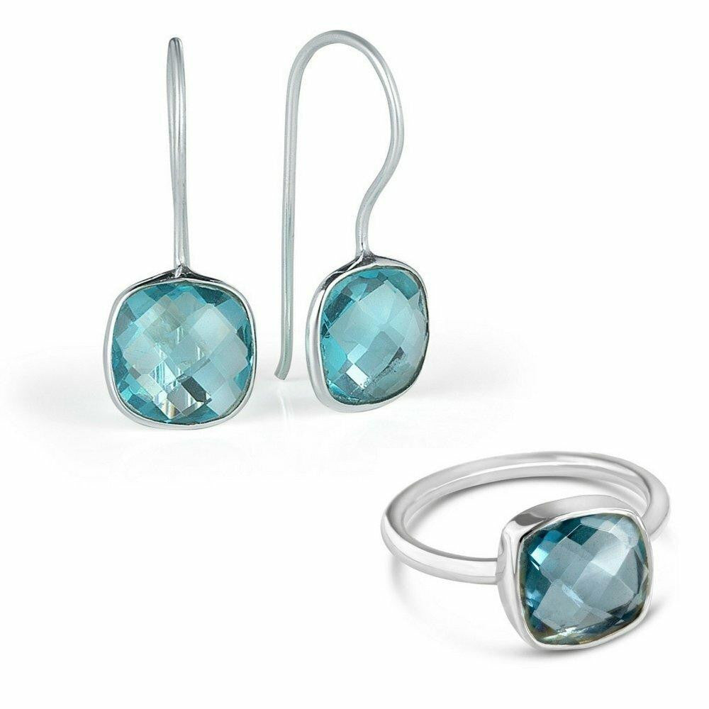 blue topaz earrings and cocktail ring in silver on a white background