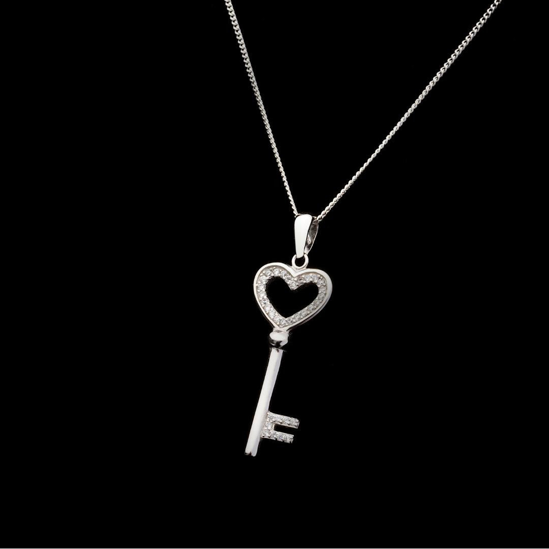 love key pendant in silver on a black background