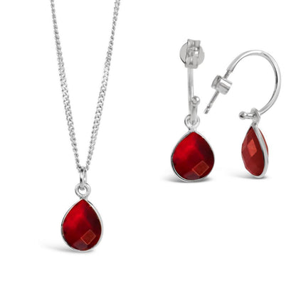 garnet charm necklace and drop hoop earrings on a white background