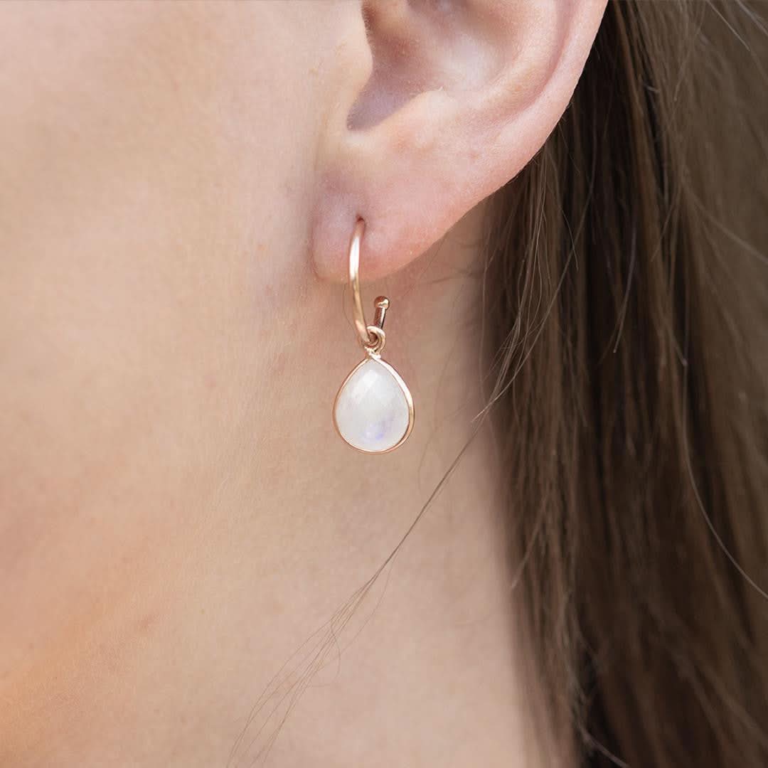 close up of model wearing moonstone drop hoop earrings 