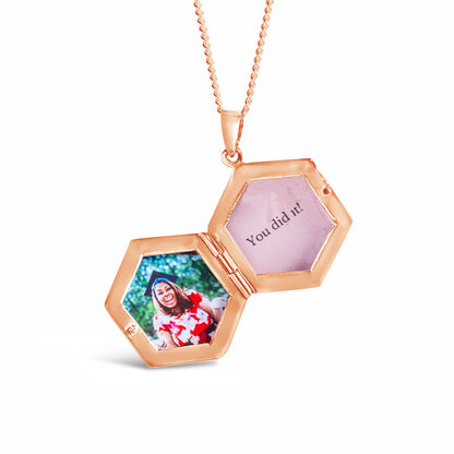 opened locket in rose gold with family photos inside