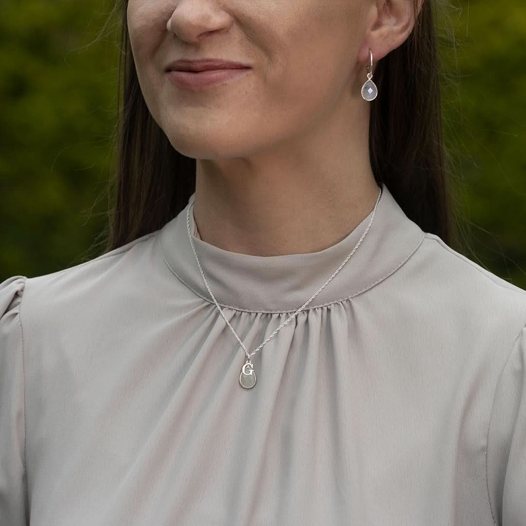 model wearing moonstone charm necklace in silver 